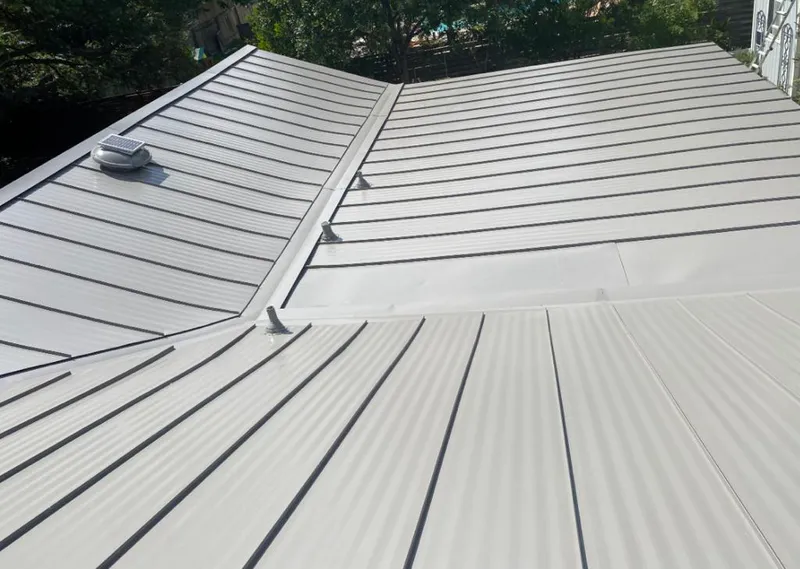 Solar attic fan installed on a metal roof for Roof Ventilation in Nantucket